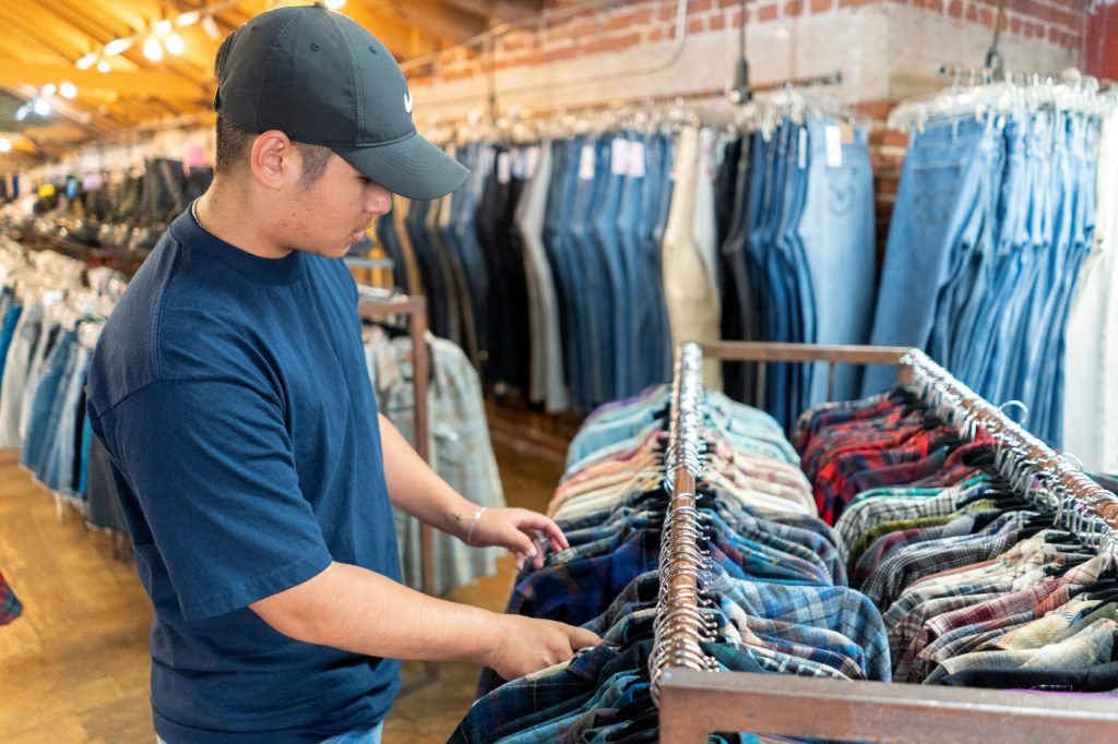 Young man shopping at a thrift store.